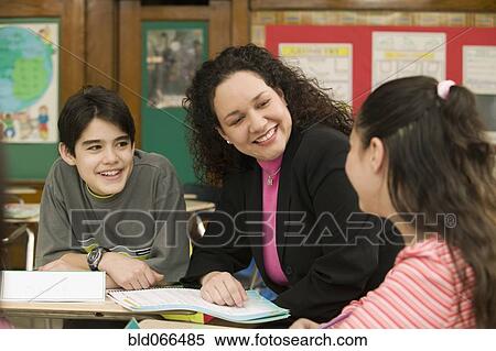 Hispanic teacher helping students View Large Photo Image Stock Photography - Hispanic teacher helping students. Fotosearch