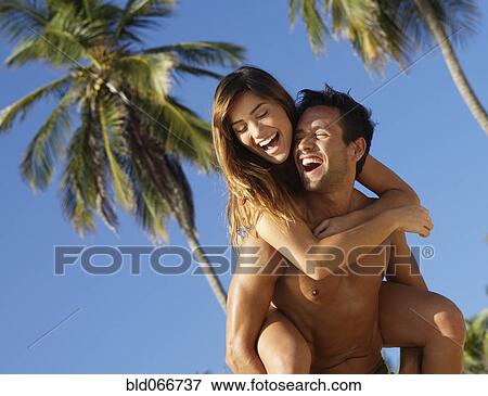 Man giving girlfriend piggyback ride View Large Photo Image Stock Photo - Man giving girlfriend piggyback ride. Fotosearch