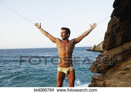 Man in bathing suit near ocean View Large Photo Image Picture - Man in bathing suit near ocean. Fotosearch