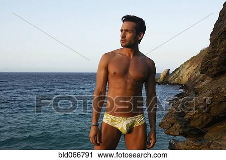 Man in bathing suit near ocean View Large Photo Image Stock Image - Man in bathing suit near ocean. Fotosearch