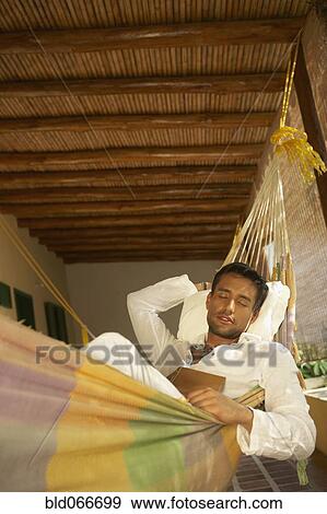 Stock Photo - Man laying in hammock. Fotosearch