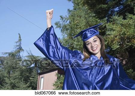 Stock Photograph - Mixed race girl celebrating graduation. Fotosearch
