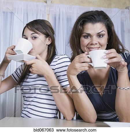 Mother and daughter drinking coffee View Large Photo Image Stock Image - Mother and daughter drinking coffee. Fotosearch