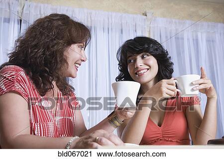 Mother and daughter enjoying coffee together View Large Photo Image Stock Image - Mother and daughter enjoying coffee together. Fotosearch
