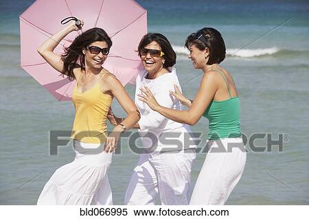 Mother and sisters playing on beach View Large Photo Image Stock Photography - Mother and sisters playing on beach. Fotosearch