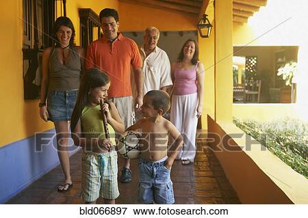 Stock Photo - Multi-generational family standing on porch. Fotosearch