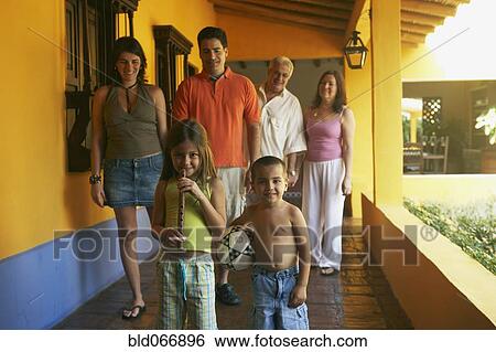 Stock Photograph - Multi-generational family standing on porch. Fotosearch