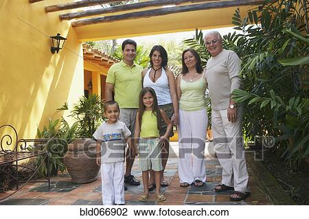 Stock Image - Multi-generational family standing outdoors. Fotosearch