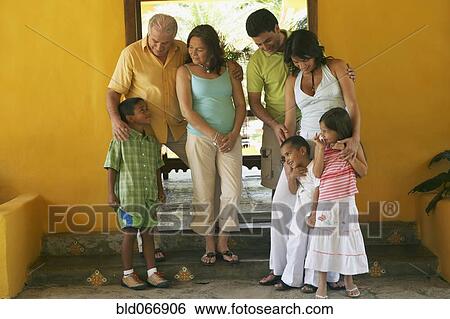 Stock Photograph - Multi-generational family standing outdoors. Fotosearch