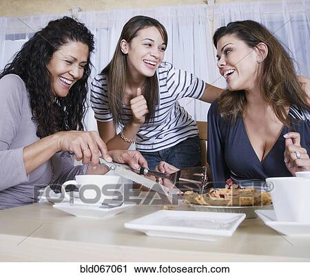 Stock Image - Multi-generational women eating homemade pie. Fotosearch
