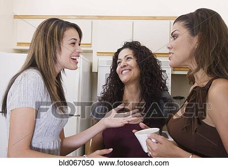 Multi-generational women talking in kitchen View Large Photo Image Stock Image - Multi-generational women talking in kitchen. Fotosearch