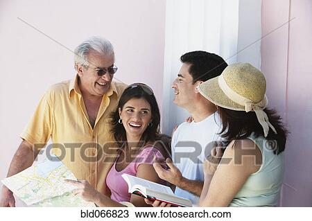 Stock Image - People looking at map. Fotosearch