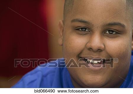 Stock Image - Portrait of African boy smiling. Fotosearch