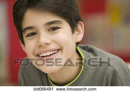 Stock Image - Portrait of Hispanic boy smiling. Fotosearch