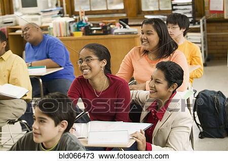 Stock Image - School teacher and students in classroom. Fotosearch