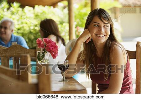 Smiling woman drinking red wine in cafe View Large Photo Image Stock Photo - Smiling woman drinking red wine in cafe. Fotosearch