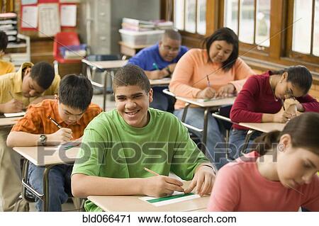 Stock Image - Students making name cards in classroom. Fotosearch