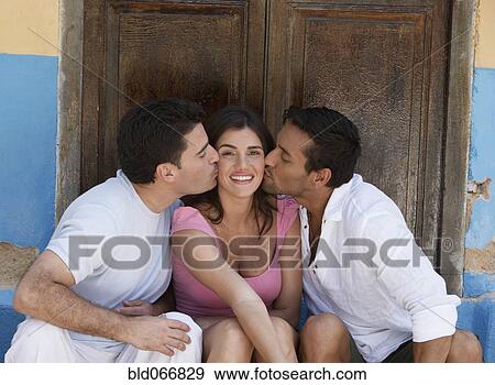 Two men kissing woman on cheek View Large Photo Image Stock Photo - Two men kissing woman on cheek. Fotosearch