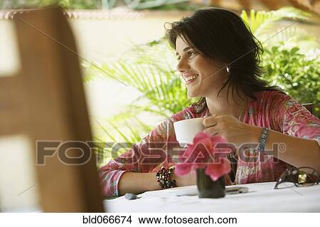 Woman drinking coffee in cafe View Large Photo Image Picture - Woman drinking coffee in cafe. Fotosearch