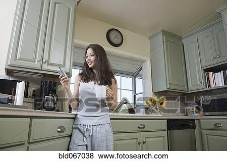 Stock Photo - Woman drinking coffee in morning. Fotosearch
