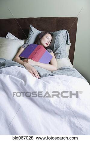 Stock Photo - Woman sleeping with book. Fotosearch
