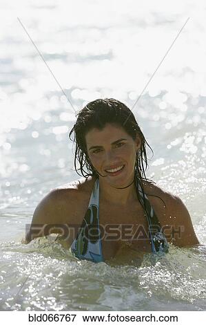 Stock Photo - Woman swimming in ocean. Fotosearch