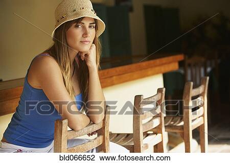 Woman wearing straw hat in bar View Large Photo Image Stock Image - Woman wearing straw hat in bar. Fotosearch