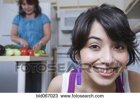 Stock Image - Young woman anticipating homemade meal. Fotosearch