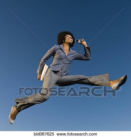 African businesswoman talking on cell phone in mid-air View Large Photo Image Stock Photography - African businesswoman talking on cell phone in mid-air. Fotosearch