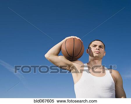 Stock Photography - African man holding basketball. Fotosearch
