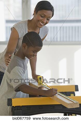 African mother and son woodworking together View Large Photo Image Stock Photo - African mother and son woodworking together. Fotosearch