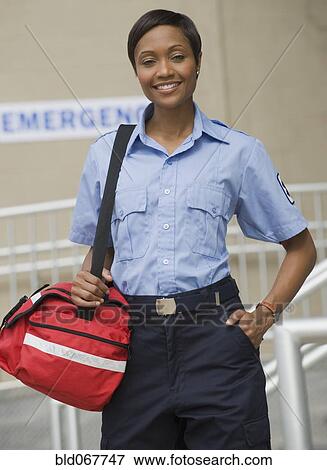 African paramedic holding first-aid kit View Large Photo Image Stock Photo - African paramedic holding first-aid kit. Fotosearch