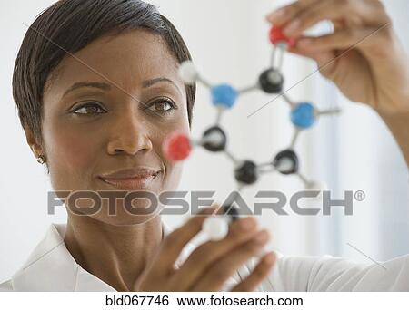 African scientist holding molecule model View Large Photo Image Stock Photograph - African scientist holding molecule model. Fotosearch