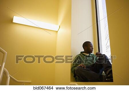 African teenager sitting in window sill View Large Photo Image Picture - African teenager sitting in window sill. Fotosearch