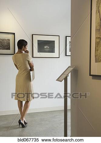 African woman enjoying photographs in museum View Large Photo Image Stock Photography - African woman enjoying photographs in museum. Fotosearch