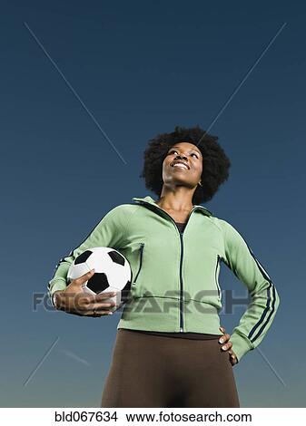 African woman holding soccer ball View Large Photo Image Picture - African woman holding soccer ball. Fotosearch