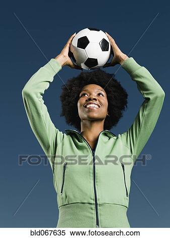 African woman holding soccer ball View Large Photo Image Stock Photography - African woman holding soccer ball. Fotosearch