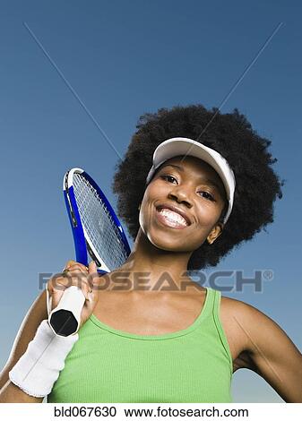 African woman holding tennis racquet View Large Photo Image Stock Image - African woman holding tennis racquet. Fotosearch