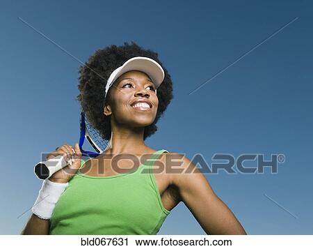 African woman holding tennis racquet View Large Photo Image Stock Image - African woman holding tennis racquet. Fotosearch