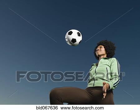 African woman kneeing soccer ball View Large Photo Image Stock Photograph - African woman kneeing soccer ball. Fotosearch