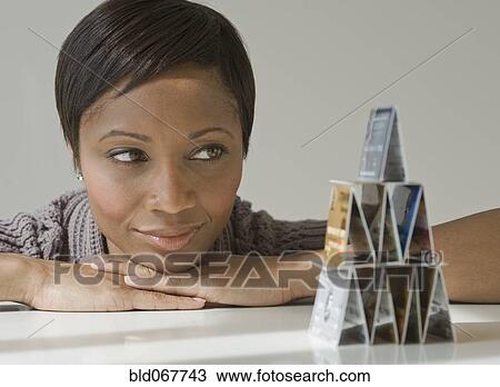 African woman looking at pyramid of credit cards View Large Photo Image Stock Image - African woman looking at pyramid of credit cards. Fotosearch