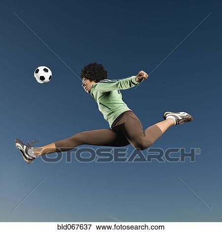 African woman playing soccer in mid-air View Large Photo Image Stock Photo - African woman playing soccer in mid-air. Fotosearch