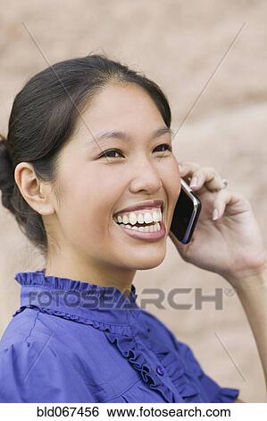 Stock Photograph - African woman talking on cell phone. Fotosearch