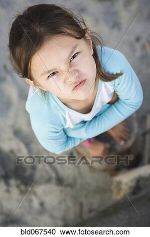 Angry Asian girl frowning View Large Photo Image Stock Image - Angry Asian girl frowning. Fotosearch