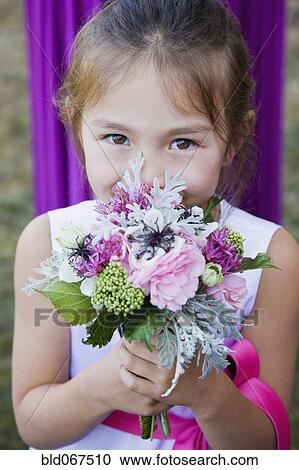 Asian flower girl holding floral bouquet View Large Photo Image Stock Image - Asian flower girl holding floral bouquet. Fotosearch