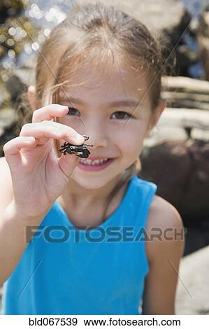 Asian girl holding tiny crab View Large Photo Image Stock Photo - Asian girl holding tiny crab. Fotosearch