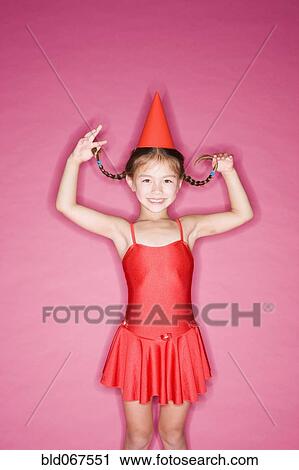 Stock Image - Asian girl in hat and ballet costume. Fotosearch