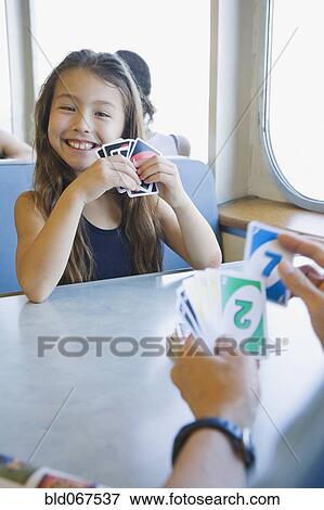 Stock Photo - Asian girl playing cards. Fotosearch