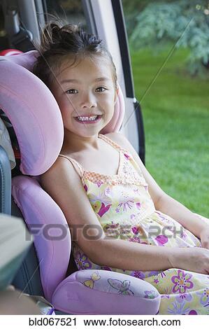 Asian girl sitting in car seat View Large Photo Image Stock Image - Asian girl sitting in car seat. Fotosearch