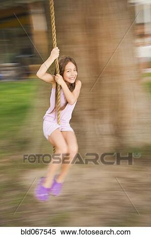 Asian girl swinging on rope swing View Large Photo Image Stock Photography - Asian girl swinging on rope swing. Fotosearch